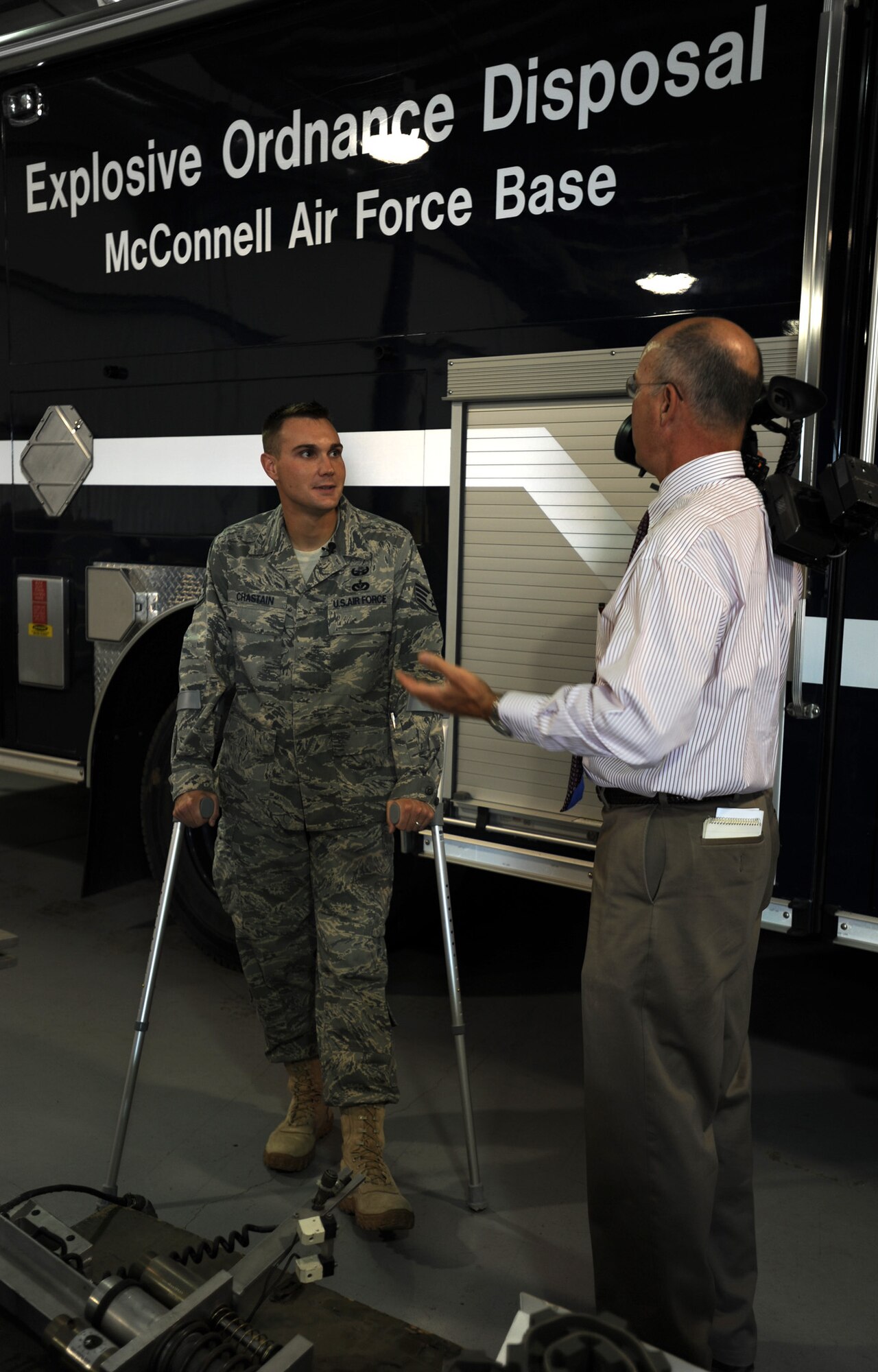 Staff Sgt. Beau Chastain, 22nd Civil Engineer Squadron Explosive Ordnance Disposal specialist, is interviewed by Chris Frank, a local news reporter June 28, 2011, McConnell Air Force Base, Kan.  Chastain returned to Wichita, Kan., after sustaining a gunshot wound to his left leg June 9, 2011, while deployed in Afghanistan.  (U.S.Air Force Photo/ Airman 1st Class Laura L. Valentine)