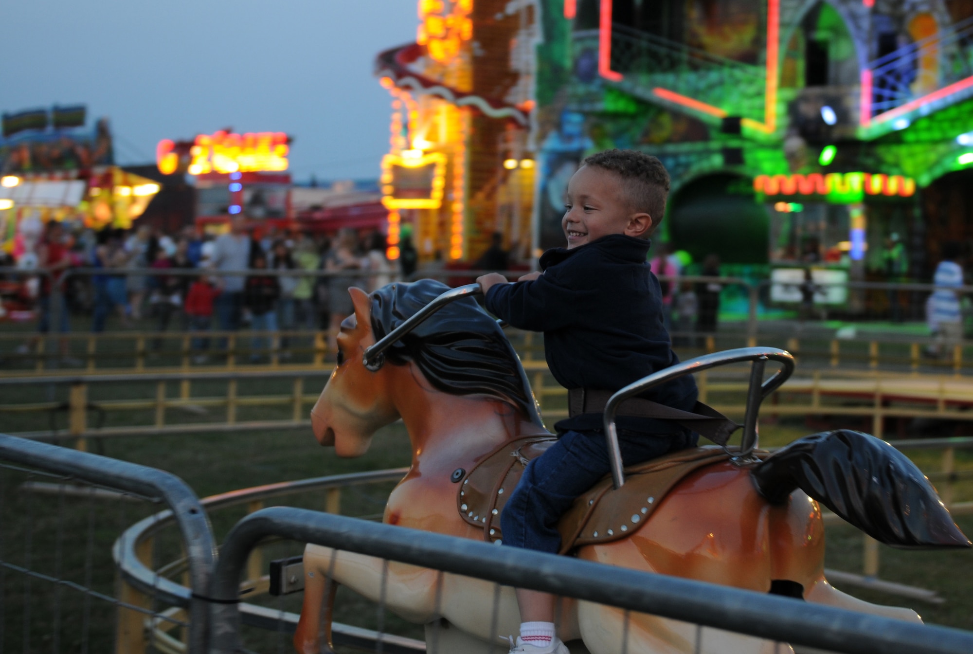 ROYAL AIR FORCE FELTWELL, England - Nathanael Beasley, local family member, rides a kiddie coaster during the Fourth of July celebration on RAF Feltwell, July 4, 2011. Airmen, their families and local community members came together to celebrate America's Independence Day with carnival games and rides, aerial displays, and a fireworks display. (U.S. Air Force photo/Airman Cory Payne)