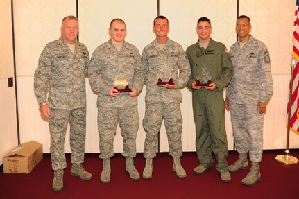 Col. Erik Hansen (left) and Chief Master Sgt. Terrence Greene (right) present Airman 1st Class Andrew Fox, Senior Airman Mitchell Parker and Staff Sgt. Kenneth Common the Diamond Sharp award during a ceremony at the Charleston Club July 5. Hansen is the 437th Airlift Wing commander, Greene is the 437 AW command chief, Fox is from the 437th Aircraft Maintenance Squadron, Parker is from the 437th Maintenance Squadron and Common is from the 16th Airlift Squadron. Diamond Sharp awardees are Airmen chosen by their first sergeants for their excellent performance. (U.S. Air Force photo/Tech. Sgt  Chrissy Best)
