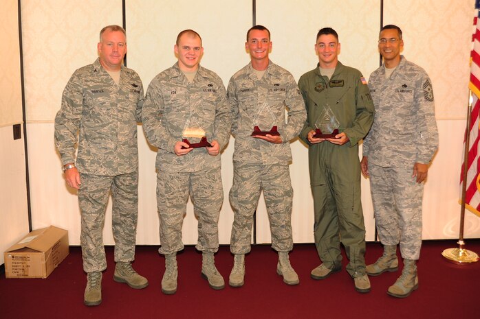 Col. Erik Hansen (left) and Chief Master Sgt. Terrence Greene (right) present Airman 1st Class Andrew Fox, Senior Airman Mitchell Parker and Staff Sgt. Kenneth Common the Diamond Sharp award during a ceremony at the Charleston Club July 5. Hansen is the 437th Airlift Wing commander, Greene is the 437 AW command chief, Fox is from the 437th Aircraft Maintenance Squadron, Parker is from the 437th Maintenance Squadron and Common is from the 16th Airlift Squadron. Diamond Sharp awardees are Airmen chosen by their first sergeants for their excellent performance. (U.S. Air Force photo/Tech. Sgt  Chrissy Best)
