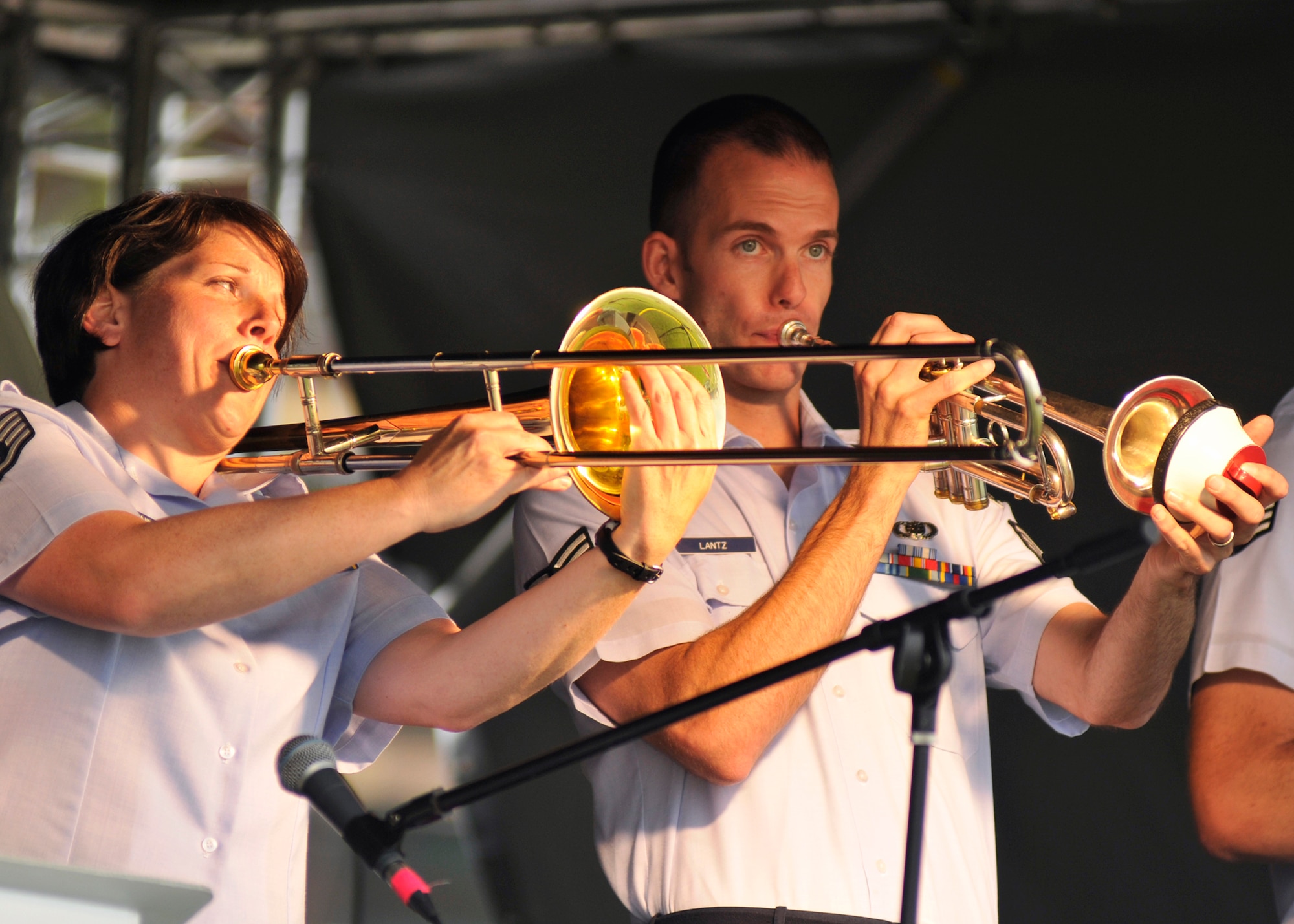 ROYAL AIR FORCE FELTWELL, England - (left to right) Staff Sgt. Saundra Sininger, United States Air Forces in Europe Wings of Dixie trombone player, and Senior Airman James Lantz, USAFE Wings of Dixie trumpet player, perform during the Fourth of July celebration, July 4, 2011.Approximately 30,000 Airmen, their families and local community members came together to celebrate America’s Independence Day. Attendees enjoyed a variety of food, played games, watched aerial displays, rode carnival rides and watched fireworks. (U.S. Air Force photo/Senior Airman Tiffany M. Deuel)