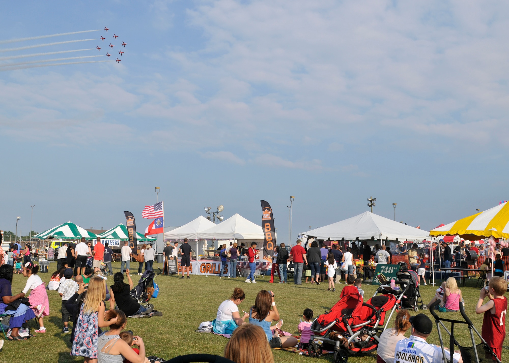 ROYAL AIR FORCE FELTWELL, England -- Celebration participants watch as the Royal Air Force Red Arrows Aerobatic Team performs during the Fourth of July celebration, July 4, 2011. Approximately 30,000 Airmen, their families and local community members came together to celebrate America’s Independence Day. Attendees enjoyed a variety of food, played games, watched aerial displays, rode carnival rides and watched fireworks. (U.S. Air Force photo/Senior Airman Tiffany M. Deuel)