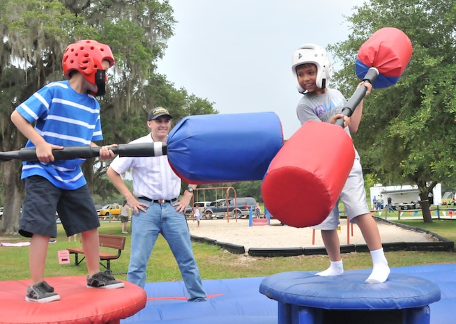 Jacob Louis (left) battles his friend Neil Capalungan while Electrician’s Mate 3rd Class Joseph Grahm referees during Freedom Fest 2011 at Joint Base Charleston – Air Base June 1. Jacob is the son of Machinist’s Mate 3rd Class Caleb Ginorio, a student at the Navy Nuclear Power Training Command and Neil is the grandson of retired Lt. Col. Alan Capalungan. Grahm is a student at NNPTC.

