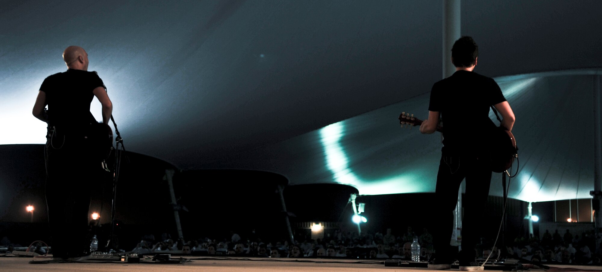 Vertical Horizon lead singer, Matt Scannell, and guitarist, Stephen Fekete, perform during an Independence Day celebration held for deployed military members at the 379th Air Expeditionary Wing and partner units in Southwest Asia, July 4. The band performed a two-night show to bolster the morale of those serving in the area of responsibility. (U.S. Air Force photo/Senior Airman Paul Labbe)