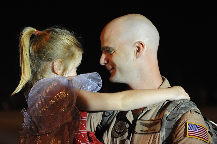 1st Lt. Grant Daniel Pool greets his daughter Nadia on the flightline July 1 at Joint Base Charleston -  Air Base, S.C.  Lieutenant Pool was one of more than 120 Airmen from the 17th Airlift Squadron returning home after a four-month deployment to the Middle East. While deployed, the Airmen flew roughly 2, 850 sorties and airlifted more than 107 million pounds of cargo through out the area of responsibility.  (U.S. Air Force photo Staff Sgt. Nicole Mickle) 