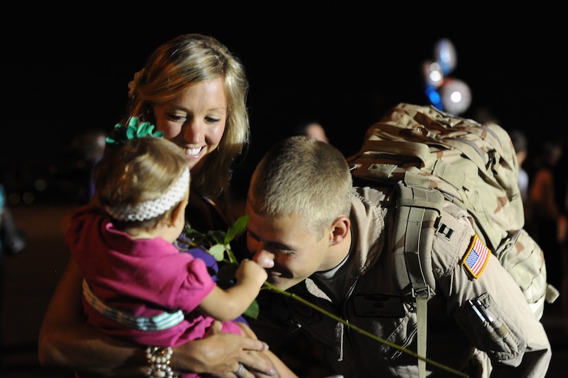 Capt. Grant Scholl greets his daughter Ayla and wife Rachel on the flightline July 1, Joint Base Charleston Air Base, S.C.  Captain Scholl was one of more than 120 Airmen from the 17th Airlift Squadron returning home after a four-month deployment to the Middle East.  While deployed, the Airmen flew roughly 2, 850 sorties and airlifted more than 107 million pounds of cargo throughout the area of responsibility.  (U.S. Air Force photo Staff Sgt. Nicole Mickle)