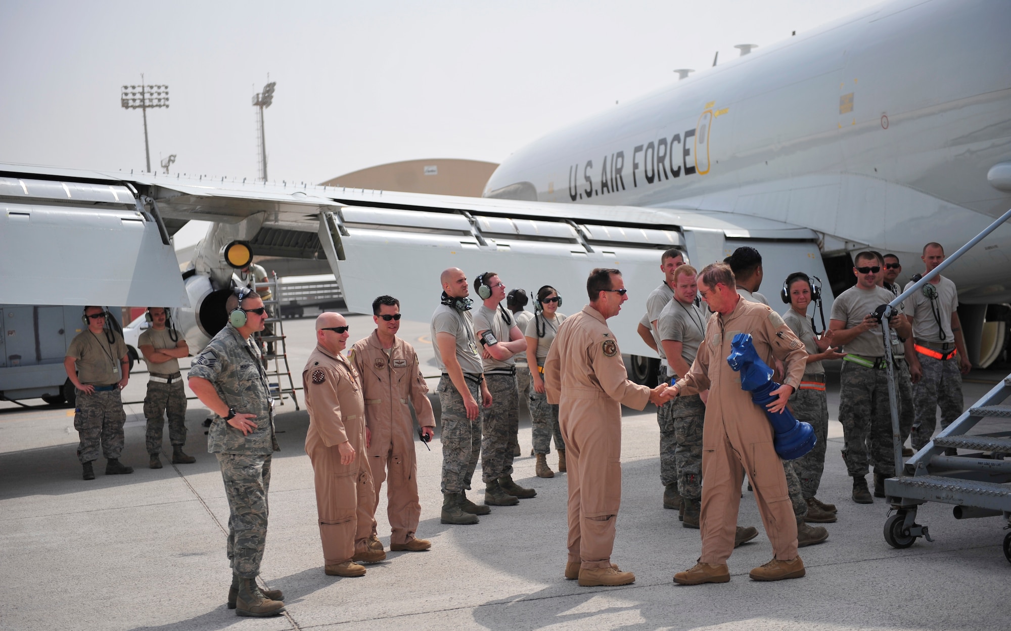 Col. Jay Bickley, 380th Expeditionary Operations Group commander, greets Maj. Jon Williams after he  reached 10,000 flying hours in the E-3 Sentry Airborne Warning and Control System, or AWACS, July 4, 2011. Maj. Williams is a mission crew commander for the 963rd Expeditionary Airborne Air Control Squadron, and he acheived a feat that has only been reached a handful of times in the history of the aircraft. (Air Force photo/Staff Sgt. Patrick Mitchell) 
