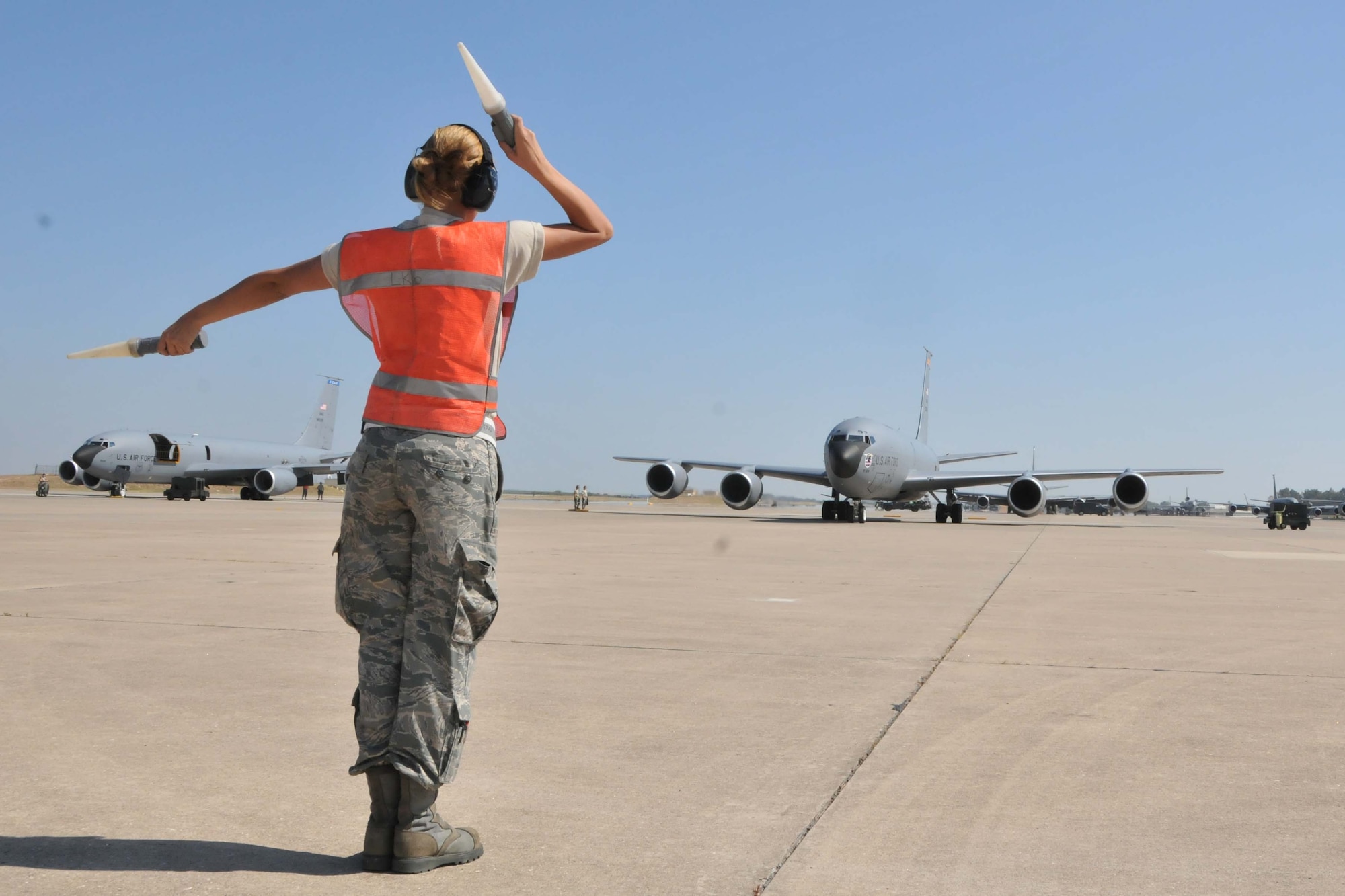Airman 1st Class Kristin Love marshals a KC-135 "Stratotanker" off the parking ramp prior to take-off at the 313th Air
Expeditionary Wing in Western Europe on July 4, 2011. (U.S. Air Force photo/Capt. John P. Capra)
