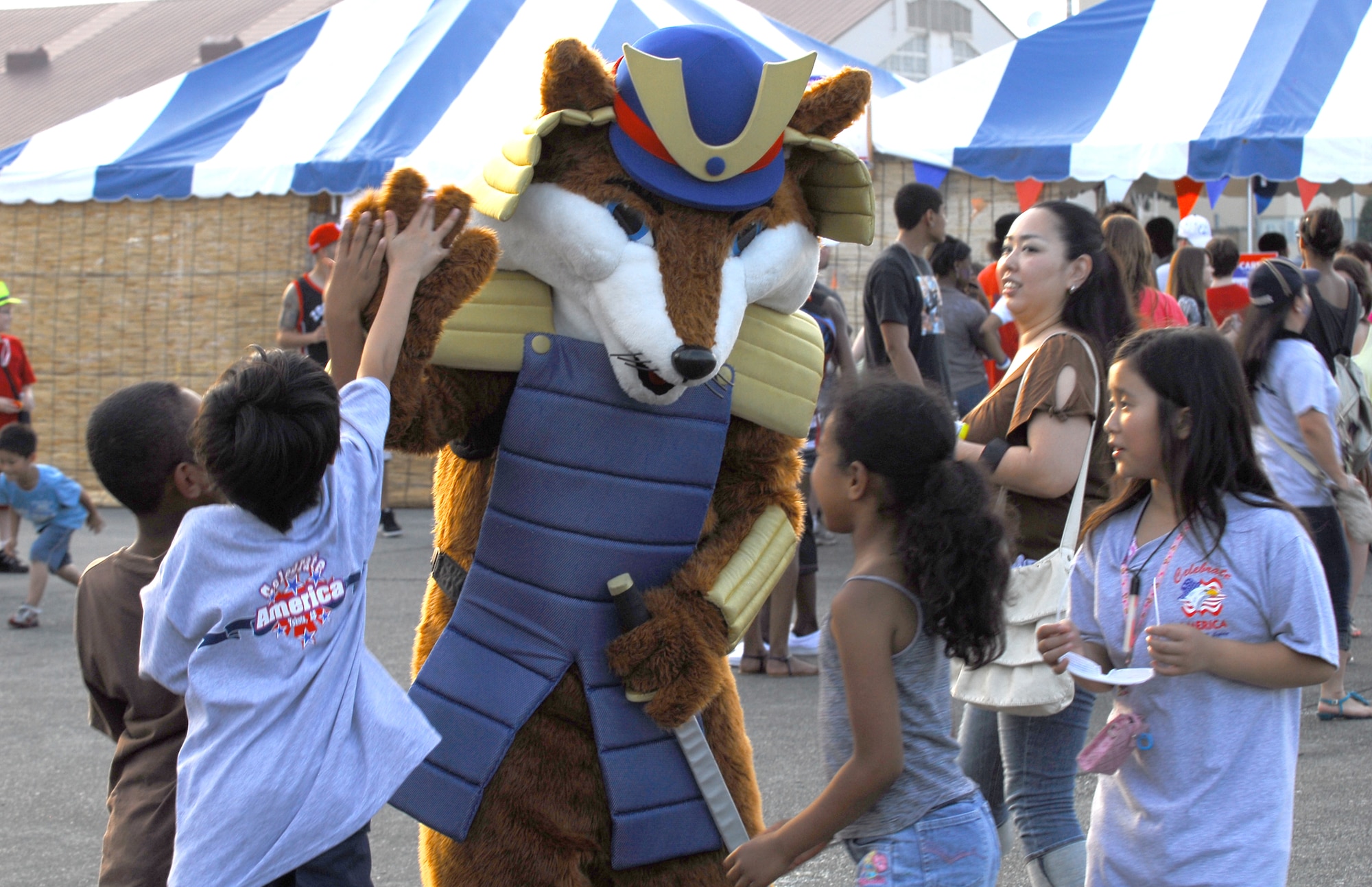 YOKOTA AIR BASE, Japan -- Children meet with the "Samurai Fox" mascot from the 374th Force Support Squadron during the Celebrate America event held July 2, 2011, at Yokota Air Base, Japan. The festivities also included face painting, go-carts, petting zoo and fireworks show. (U.S. Air Force photo/Staff Sgt. Robin Stanchak)