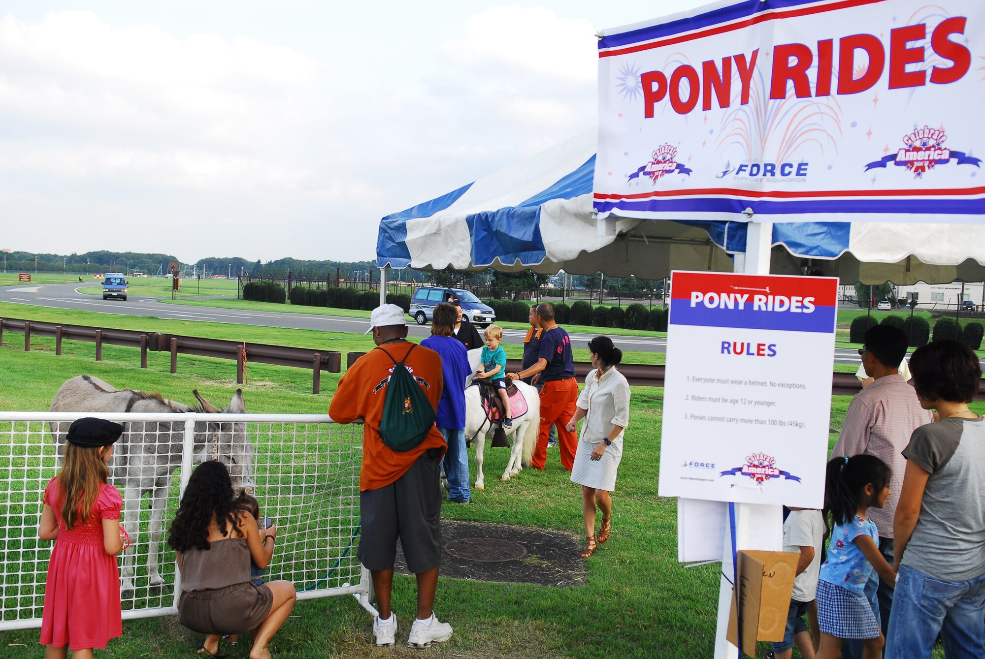 YOKOTA AIR BASE, Japan -- Children enjoy pony rides at the Celebrate America event held July 2, 2011, at Yokota Air Base, Japan. The festivities also included face painting, carnival games, arts and crafts, and a fireworks show. (U.S. Air Force photo/Staff Sgt. Robin Stanchak)