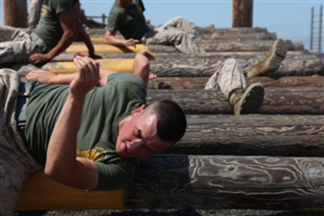U.S. Marine Corps Cpl. Joshua Thomas, a corporal's course student at Marine Corps Air Station Miramar, weaves over and under logs while completing a confidence course at Marine Corps Recruit Depot, San Diego, on June 27, 2011.  The course provides corporals with the education and leadership skills necessary to lead Marines.  