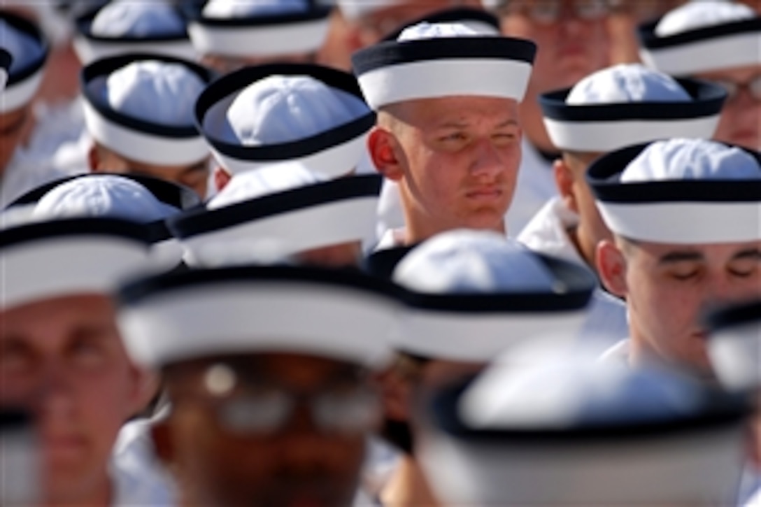 Plebes from the U.S. Naval Academy Class of 2015 wait to be officially sworn in at the conclusion of Induction Day, marking the beginning of Plebe Summer, six-weeks of training intended to transition the students from civilian to military life at the Naval Academy, Annapolis, Md., June 30, 2011.