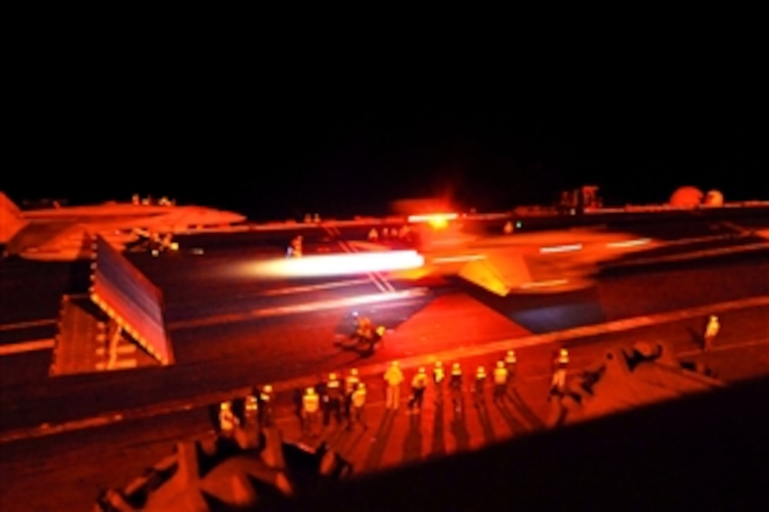 An F/A-18E Super Hornet launches from the aircraft carrier USS George Washington during night flight operations while under way in the South China Sea, July 1, 2011. The George Washington is underway in the U.S. 7th Fleet area of responsibility.