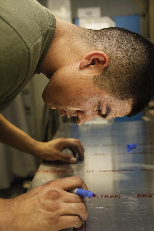 Cpl Alexander Perez, a native of Hutto, Texas, takes measurements for a future project at Camp Bastion, Afghanistan, July 6. Perez is an airframes mechanic with Marine Aviation Logistics Squadron 40.