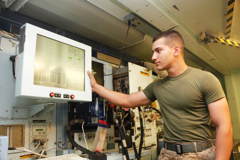 Lance Cpl. Mohammad Abdelhadi, a native of Irvine, Calif., installs a new circuit card assembly for a flight control computer at Camp Bastion, Afghanistan, July 6. Abdelhadi is a consolidated automated support system technician with Marine Aviation Logistics Squadron 40.
