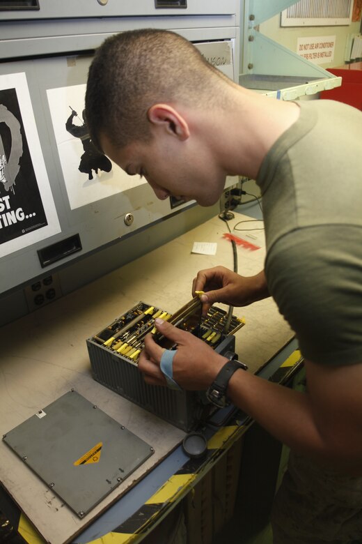 Lance Cpl. Mohammad Abdelhadi, a native of Irvine, Calif., monitors a screen to verify tests results for the flight control computer at Camp Bastion, Afghanistan, July 6. Abdelhadi is a consolidated automated support system technician with Marine Aviation Logistics Squadron 40.