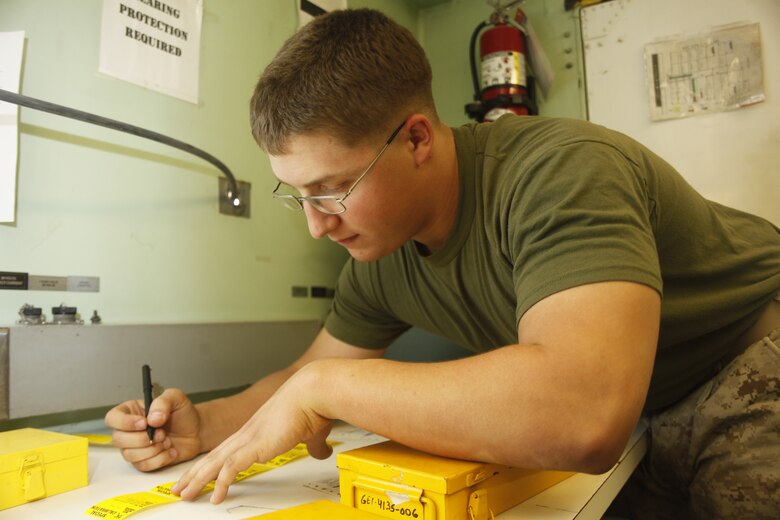 Cpl. Brandon Kiefer, a native of Decatur, Ill., prepares calibration tags at Camp Bastion, Afghanistan, July 6. Kiefer is a calibration technician with Marine Aviation Logistics Squadron 40.