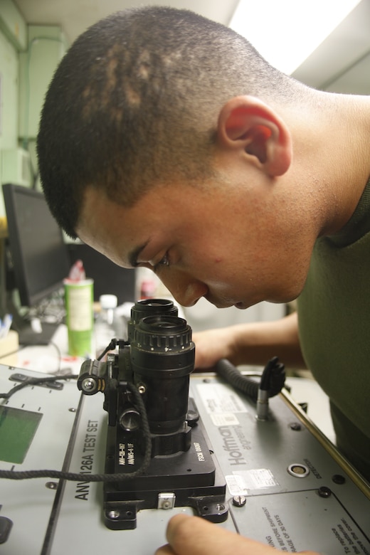 Cpl. Robert Calderon, a native of Miami, prepares to test a pair of night vision goggles at Camp Bastion, Afghanistan, July 6. Calderon is an avionics technician with Marine Aviation Logistics Squadron 40.