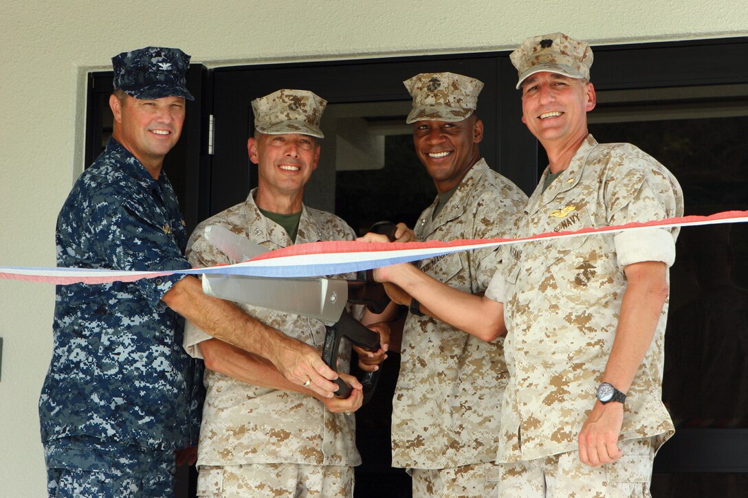 From left to right, Navy Capt. Terry J. Moulton, commanding officer of U.S. Naval Hospital Okinawa, Maj. Gen. Peter J. Talleri, commanding general, Marine Corps Base Camp Butler and deputy commander for Marine Corps Bases Japan, Brig. Gen. Craig C. Crenshaw, commanding general, 3rd Marine Logistics Group, and Navy Capt. Michael J. Wolfgang commanding officer, 3rd Dental Battalion, cut the ribbon at the grand reopening of the Evans Medical and Dental Clinic on Camp Foster July 6.