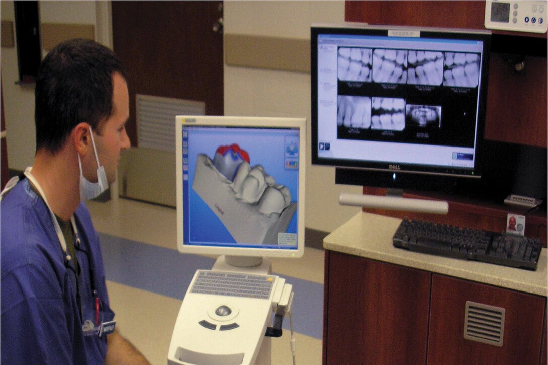Navy Lt. Joseph R. Muckenthaler, and general dentist for Evans Branch Dental Clinic, 3rd Dental Battalion, 3rd Marine Logistics Group, III Marine Expeditionary Force, uses high-technology equipment and graphics programs to design a crown for his patient. The cutting-edge technology allows dental professionals to reconstruct a missing tooth’s shape and surface, better serving dental patients, according to Cmdr. Benjamin W. Young, the dental director at the clinic, 3rd Dental Bn.