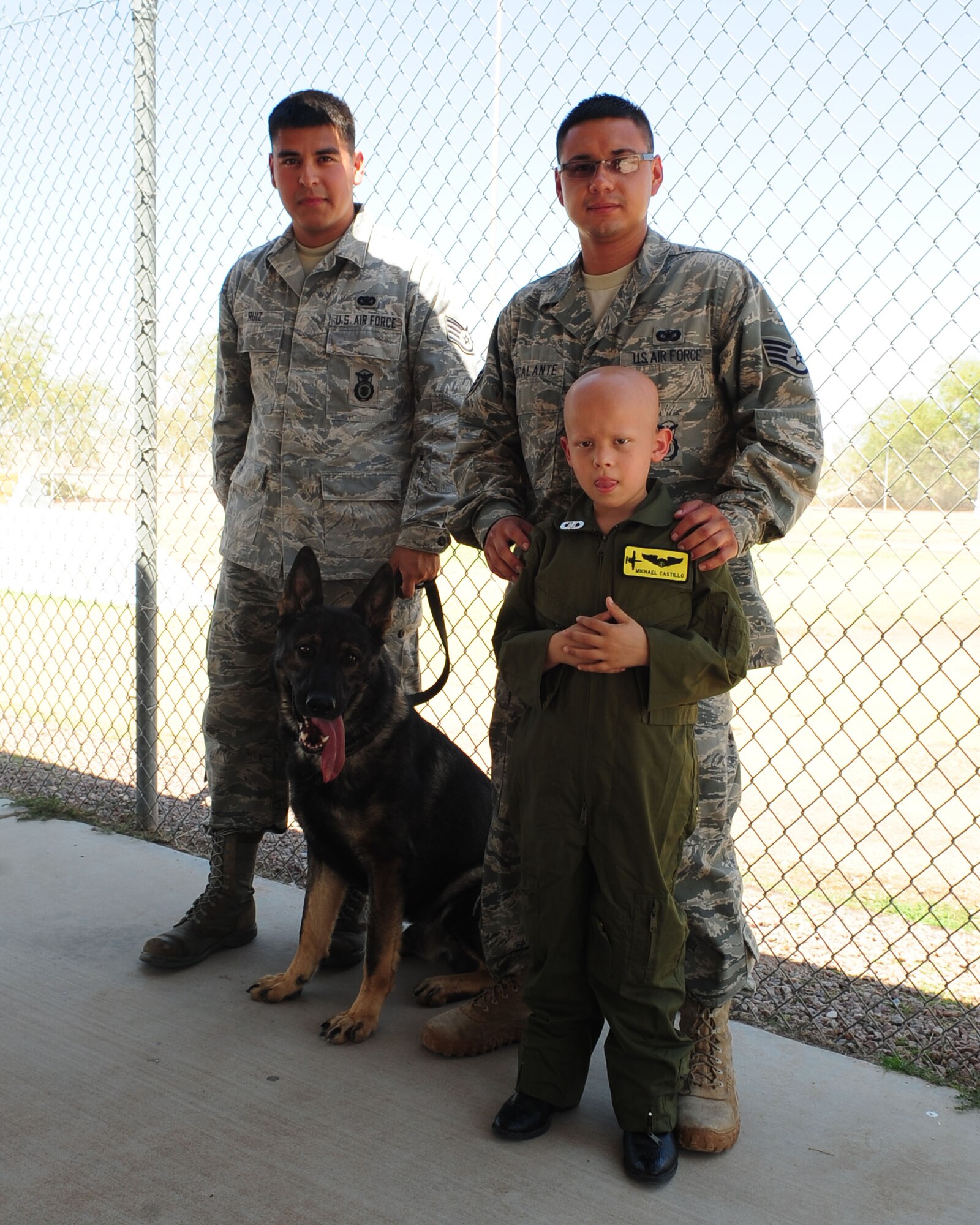 DAVIS-MONTHAN AIR FORCE BASE, Ariz. -Pilot for a Day participant, Michael Castillo, poses for a photo along side members of the 355th Security Forces military working dog unit here June 24. (U.S. Air Force photo/Airman 1st Class Jerilyn Quintanilla)