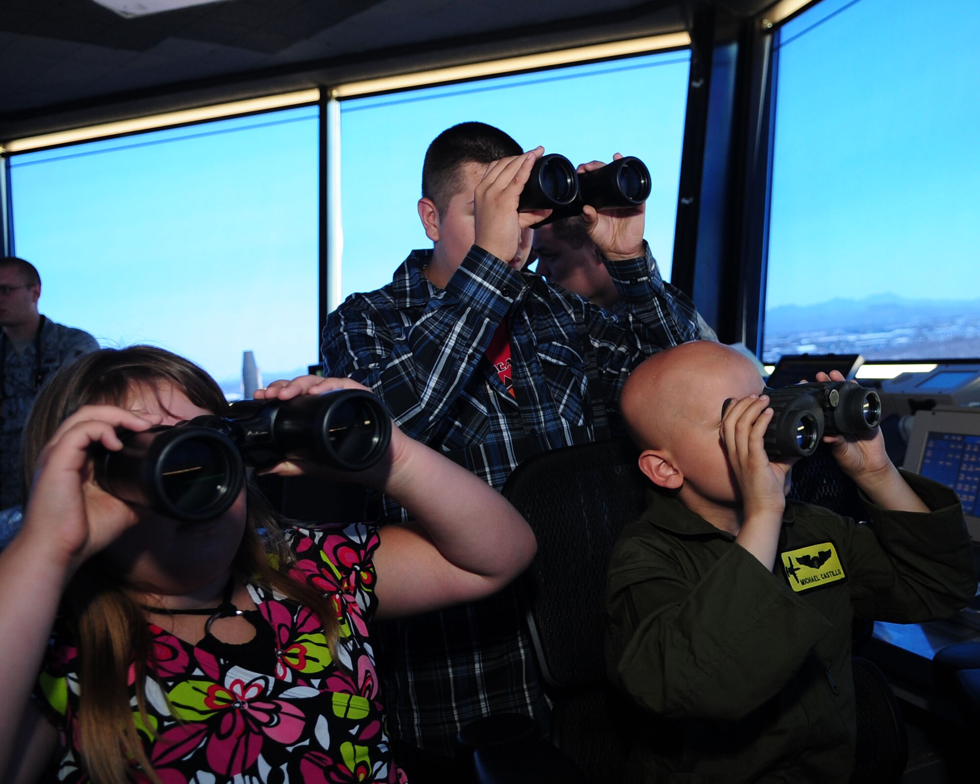 DAVIS-MONTHAN AIR FORCE BASE, Ariz. - Pilot for a Day participant, Michael Castillo, right and his cousins Angel and Lanysa get a different view of the base from the Air Traffic Control tower during a tour of the base June 24. (U.S. Air Force photo/Airman 1st Class Jerilyn Quintanilla)