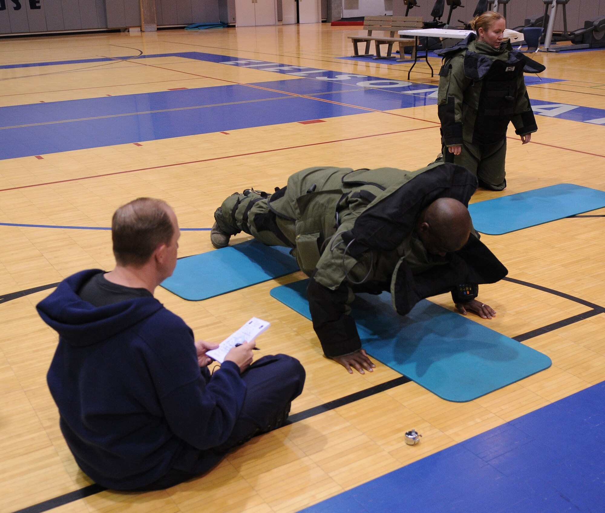 Command Chief Master Sgt. Jerry Moore performs push-ups in an Explosive Ordnance Disposal bomb suit June 28, 2011, Eielson Air Force Base, Alaska. As a participant in the second annual First Sergeants' Push-up a-thon, the command chief opted to wear the bomb suit for a greater challenge. Chief Moore is the 354th Fighter Wing Command Chief. (U.S. Air Force photos by/Airman 1st Class Janine Thibault)