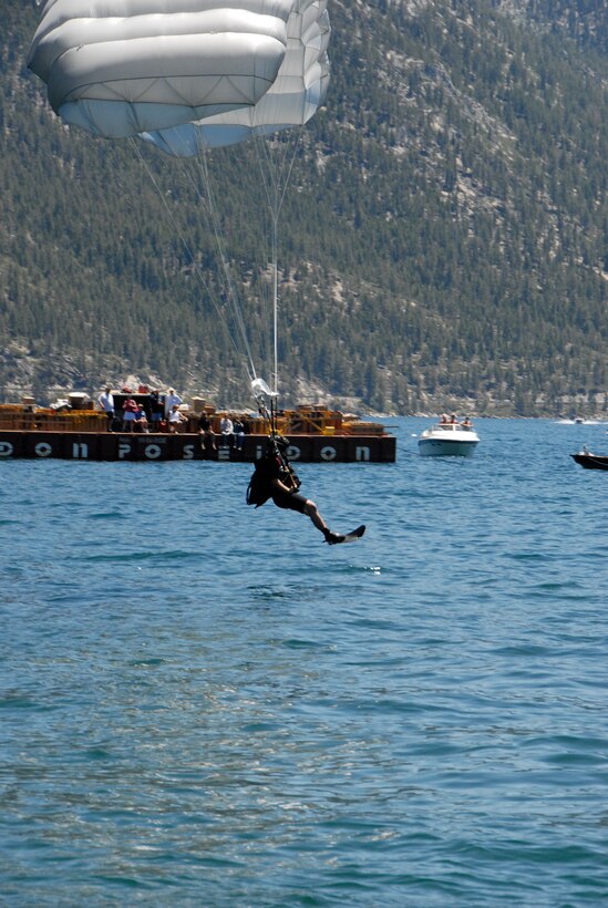 Staff Sgt. Mickey Chan, a pararescueman assigned to the California Air National Guard’s 131st Rescue Squadron, prepares to land in Lake Tahoe after parachuting from 5,000 feet out of an MC-130P Combat Shadow to perform a simulated rescue near Incline Village, Nev. on July. Members from the 129th Rescue Wing, stationed at Moffett Federal Airfield, Calif., participated in Lake Tahoe’s fifth annual Red White and Tahoe Blue 4th of July celebration in Incline Village by providing a live aerial demonstration utilizing the wing’s MC-130P Combat Shadow fixed-wing four-engine aircraft, HH-60G Pave Hawk rescue helicopter and "Guardian Angel" pararescuemen. (Air National Guard photo by Senior Airman Jessica Green)