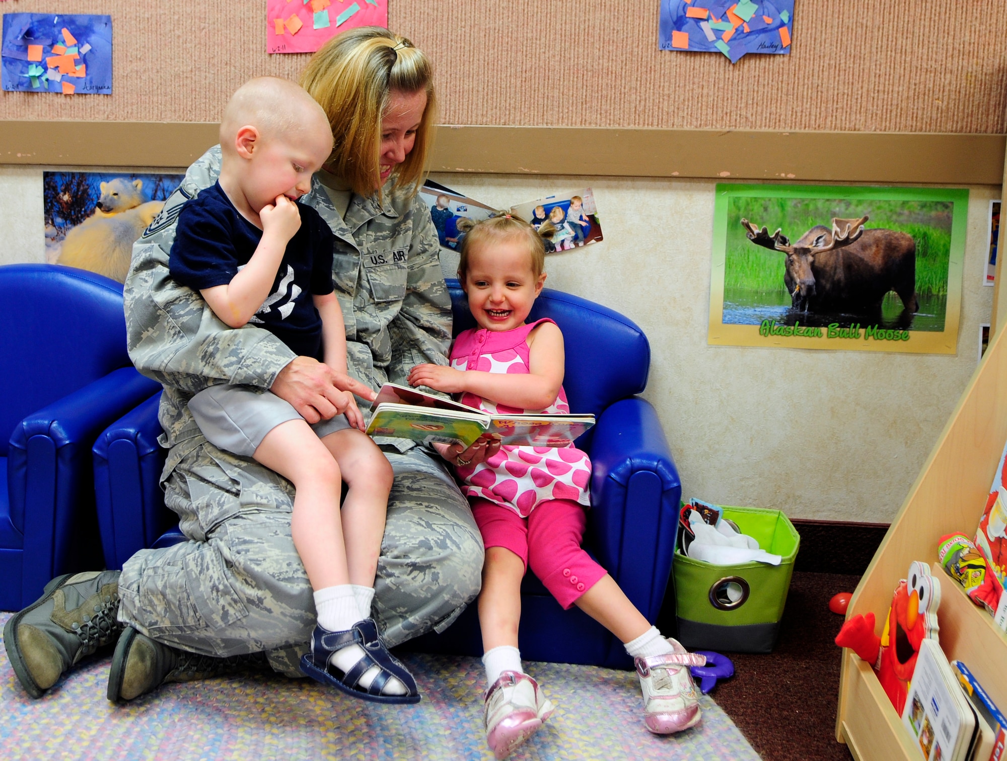Hailey and Anthony Porreca, listen as their mom, Master Sgt. Michelle Porreca, reads a story at the Child Development Center June 29, 2011, Eielson Air Force Base, Alaska.  The CDC and the Youth Center offer care for children so parents can avoid leaving children unsupervised during the duty day and on special occasions.  Sergeant Porreca is the 354th Comptroller Squadron chief of financial services office.  (U.S. photo/Airman 1st Class Yash Rojas)