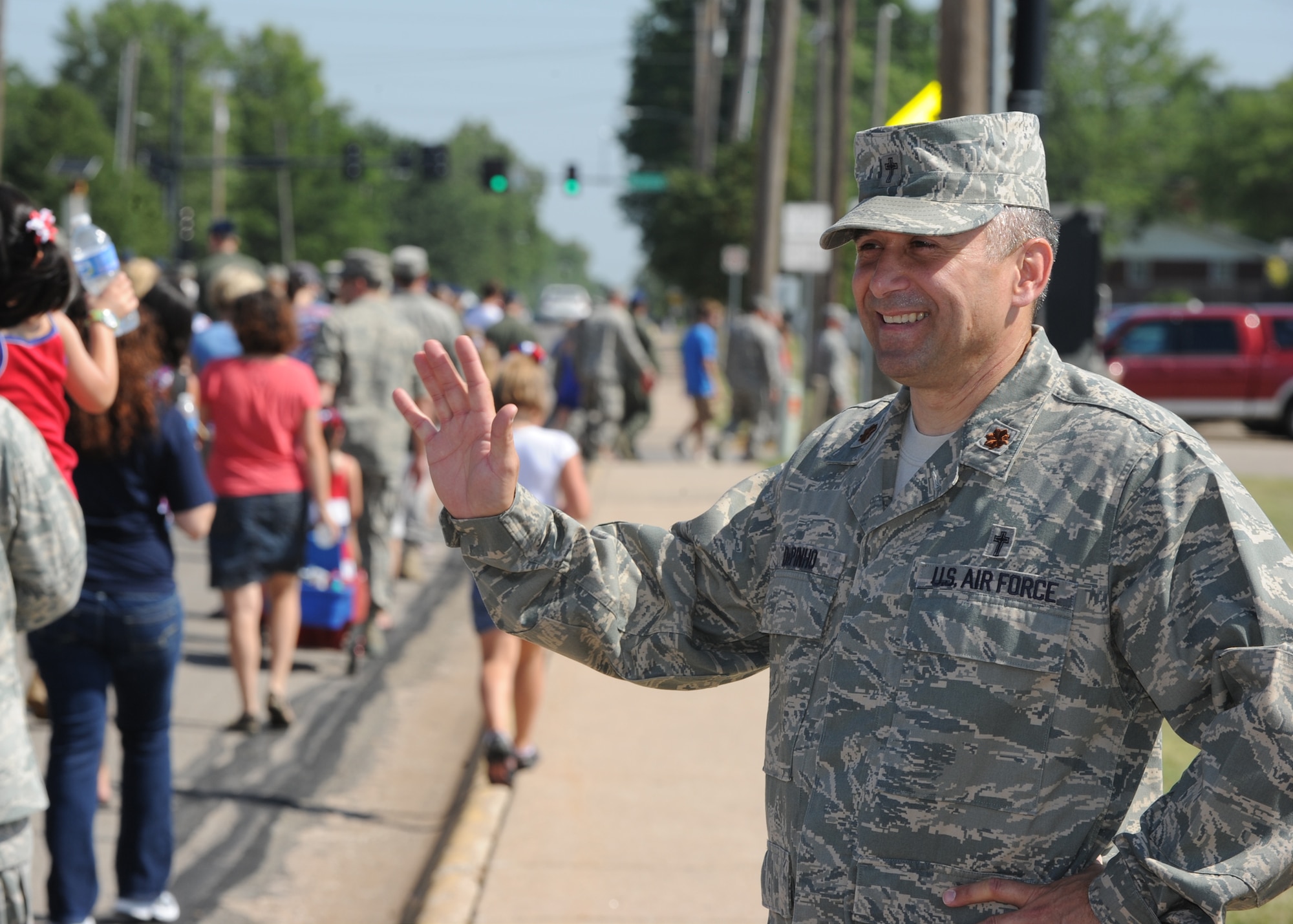 Chaplain (Maj.) David Depinho, wing chaplain of the 22nd Air Refueling Wing , waves to Airmen and families during a parade July 4, 2011, Derby, Kan. Nearly 200 Airmen from McConnell Air Force Base, Kan., participated in the 2011 Derby Independence Day Parade. The parade concluded with a community gathering, increasing involvement between the base and local area residents. (U.S. Air Force photo/ Airman 1st Class Armando A. Schwier-Morales) 