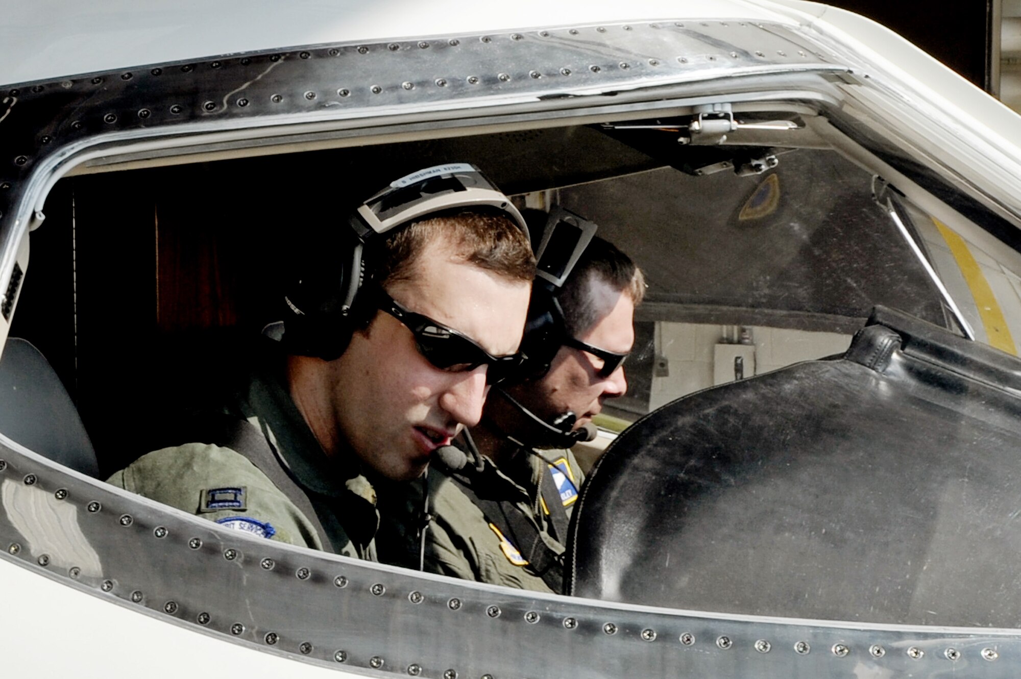 Capt. Shaun Hibshman, 76th Airlift Squadron, and Maj. Matthew Dooley, 458th Airlift Squadron, perform pre-flight checks prior to take-off during the first flight of the instructor pilot course at the C-21A formal training unit at Scott Air Force Base, Ill. July 6, 2011. Captain Hibshman was the first to fly in the instructor pilot course under the 458th AS since it regained the C-21 training mission from the 45th AS at Kessler AFB, Miss. Captain Hibshman will return to the 76th AS at Ramstein Air Base upon graduation. (U.S. Air Force Photo/Staff Sgt. Brian J. Valencia)