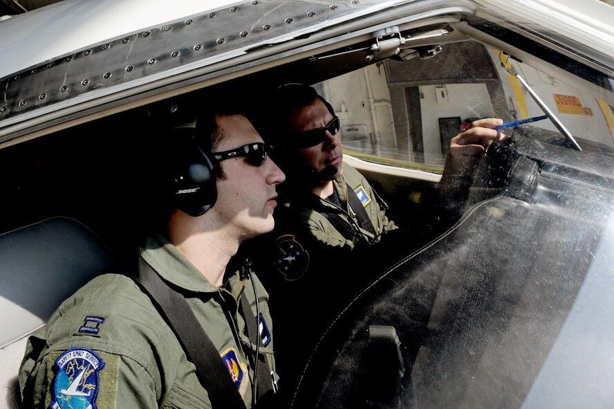 Capt. Shaun Hibshman, 76th Airlift Squadron, and Maj. Matthew Dooley, 458th Airlift Squadron, check the pre-flight checklist prior to take-off during the first flight of the instructor pilot course at the C-21A formal training unit at Scott Air Force Base, Ill., on July 6, 2011. Captain Hibshman was the first to fly in the instructor pilot course under the 458th AS since it regained the C-21 training mission from the 45th AS at Kessler AFB, Miss. Captain Hibshman will return to the 76th AS at Ramstein Air Base upon graduation. (U.S. Air Force Photo/Staff Sgt. Brian J. Valencia)