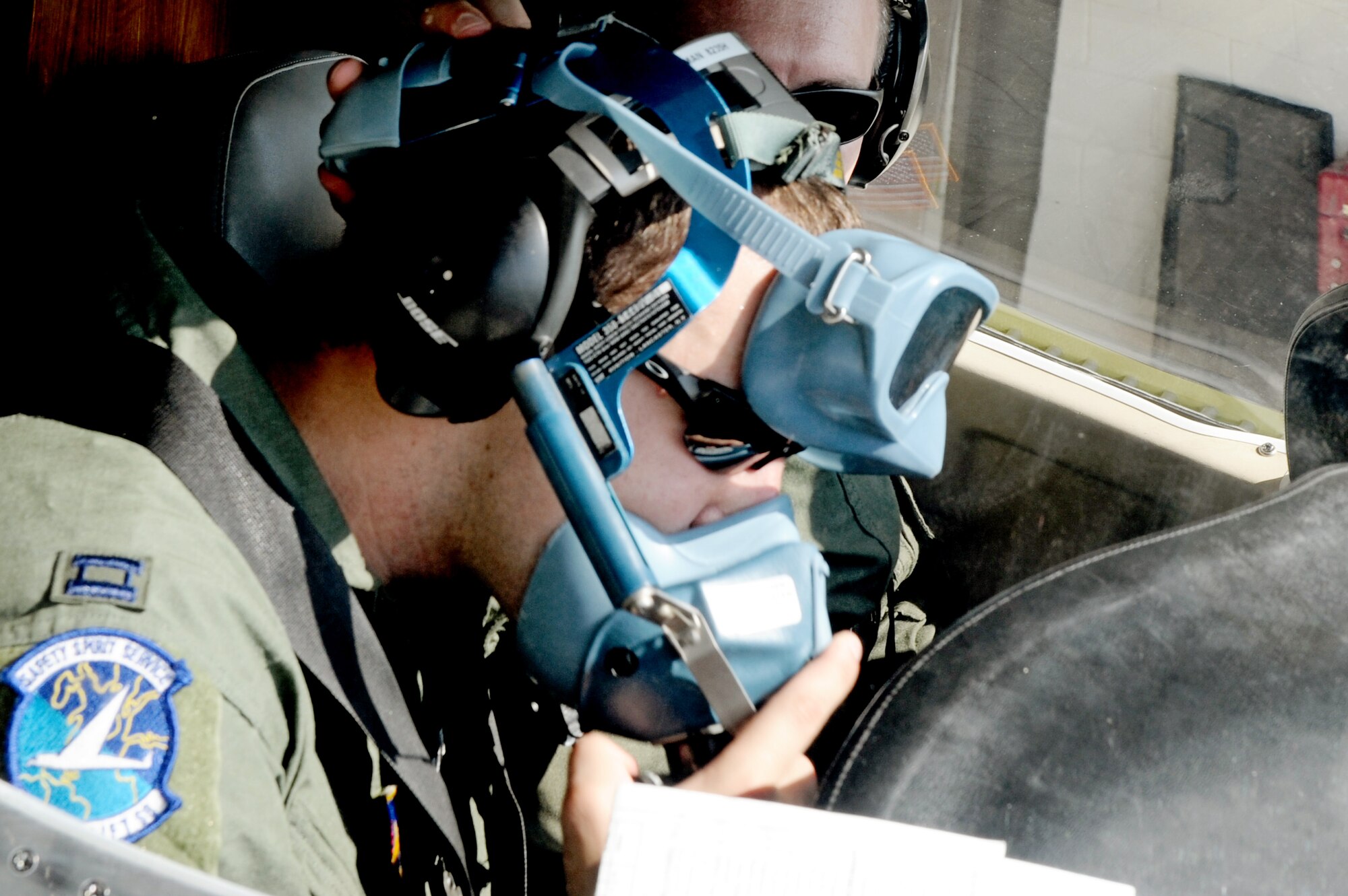 Capt. Shaun Hibshman, 76th Airlift Squadron, performs a pre-flight check of his oxygen mask prior to take-off during the first flight of the instructor pilot course at the C-21A formal training unit at Scott Air Force Base, Ill. July 6, 2011. Captain Hibshman was the first to fly in the instructor pilot course under the 458th AS since it regained the C-21 training mission from the 45th AS at Kessler AFB, Miss. Captain Hibshman will return to the 76th AS at Ramstein Air Base upon graduation. (U.S. Air Force Photo/Staff Sgt. Brian J. Valencia)