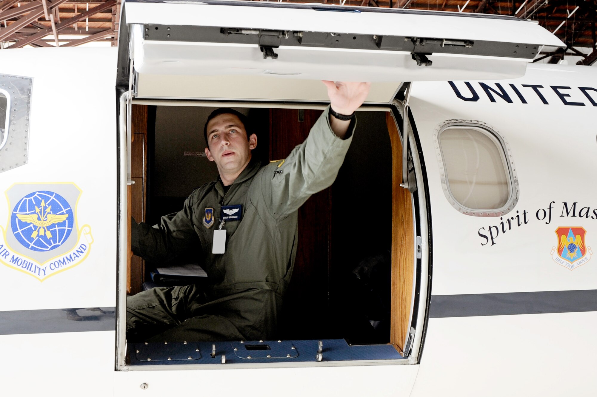 Capt. Shaun Hibshman, 76th Airlift Squadron, closes the hatch aboard a C-21 prior to take-off during the first flight of the instructor pilot course at the C-21A formal training unit at Scott Air Force Base, Ill. July 6, 2011. Captain Hibshman was the first to fly in the instructor pilot course under the 458th AS since it regained the C-21 training mission from the 45th AS at Kessler AFB, Miss. Captain Hibshman will return to the 76th AS at Ramstein Air Base upon graduation. (U.S. Air Force Photo/Staff Sgt. Brian J. Valencia)