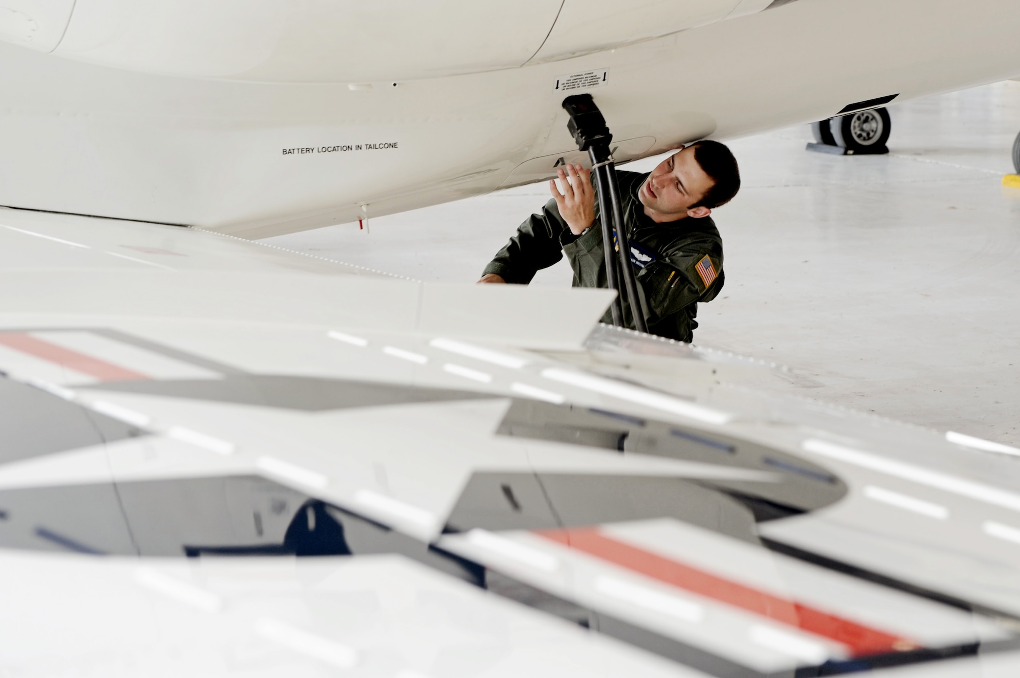 Capt. Shaun Hibshman, 76th Airlift Squadron, performs a pre-flight aircraft check prior to take-off during the first flight of the instructor pilot course at the C-21A formal training unit at Scott Air Force Base, Ill. July 6, 2011. Captain Hibshman was the first to fly in the instructor pilot course under the 458th AS since it regained the C-21 training mission from the 45th AS at Kessler AFB, Miss. Captain Hibshman will return to the 76th AS at Ramstein Air Base upon graduation. (U.S. Air Force Photo/Staff Sgt. Brian J. Valencia)