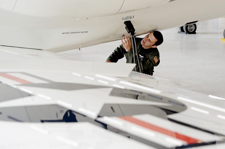 Capt. Shaun Hibshman, 76th Airlift Squadron, performs a pre-flight aircraft check prior to take-off during the first flight of the instructor pilot course at the C-21A formal training unit at Scott Air Force Base, Ill., on July 6, 2011. Captain Hibshman was the first to fly in the instructor pilot course under the 458th AS since it regained the C-21 training mission from the 45th AS at Kessler AFB, Miss. Captain Hibshman will return to the 76th AS at Ramstein Air Base upon graduation. (U.S. Air Force Photo/Staff Sgt. Brian J. Valencia) 