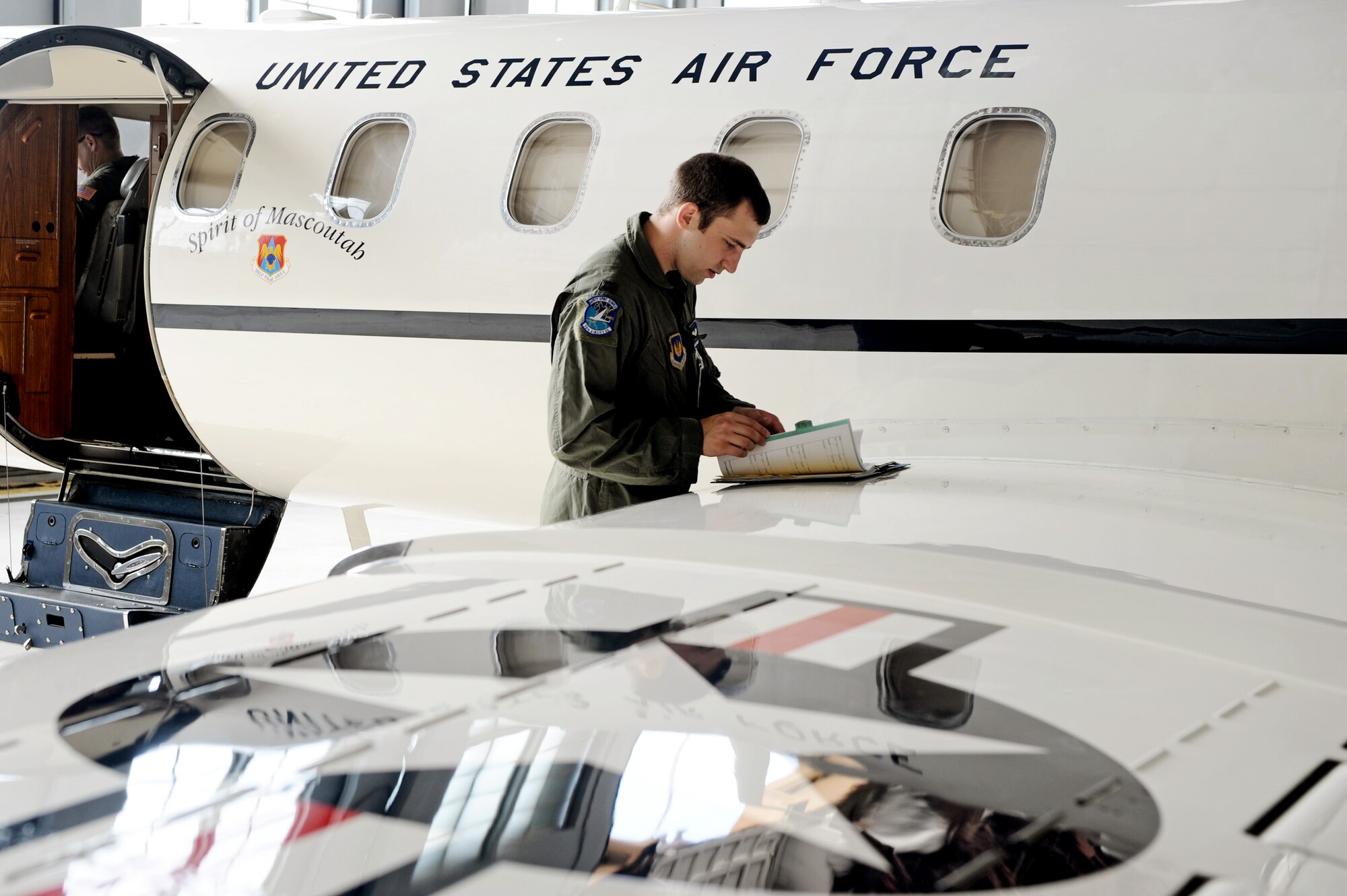 Capt. Shaun Hibshman, 76th Airlift Squadron, ensures he has all required training forms and checklists prior to take-off during the first flight of the instructor pilot course at the C-21A formal training unit at Scott Air Force Base, Ill. July 6, 2011. Captain Hibshman was the first to fly in the instructor pilot course under the 458th AS since it regained the C-21 training mission from the 45th AS at Kessler AFB, Miss. Captain Hibshman will return to the 76th AS at Ramstein Air Base upon graduation. (U.S. Air Force Photo/Staff Sgt. Brian J. Valencia)