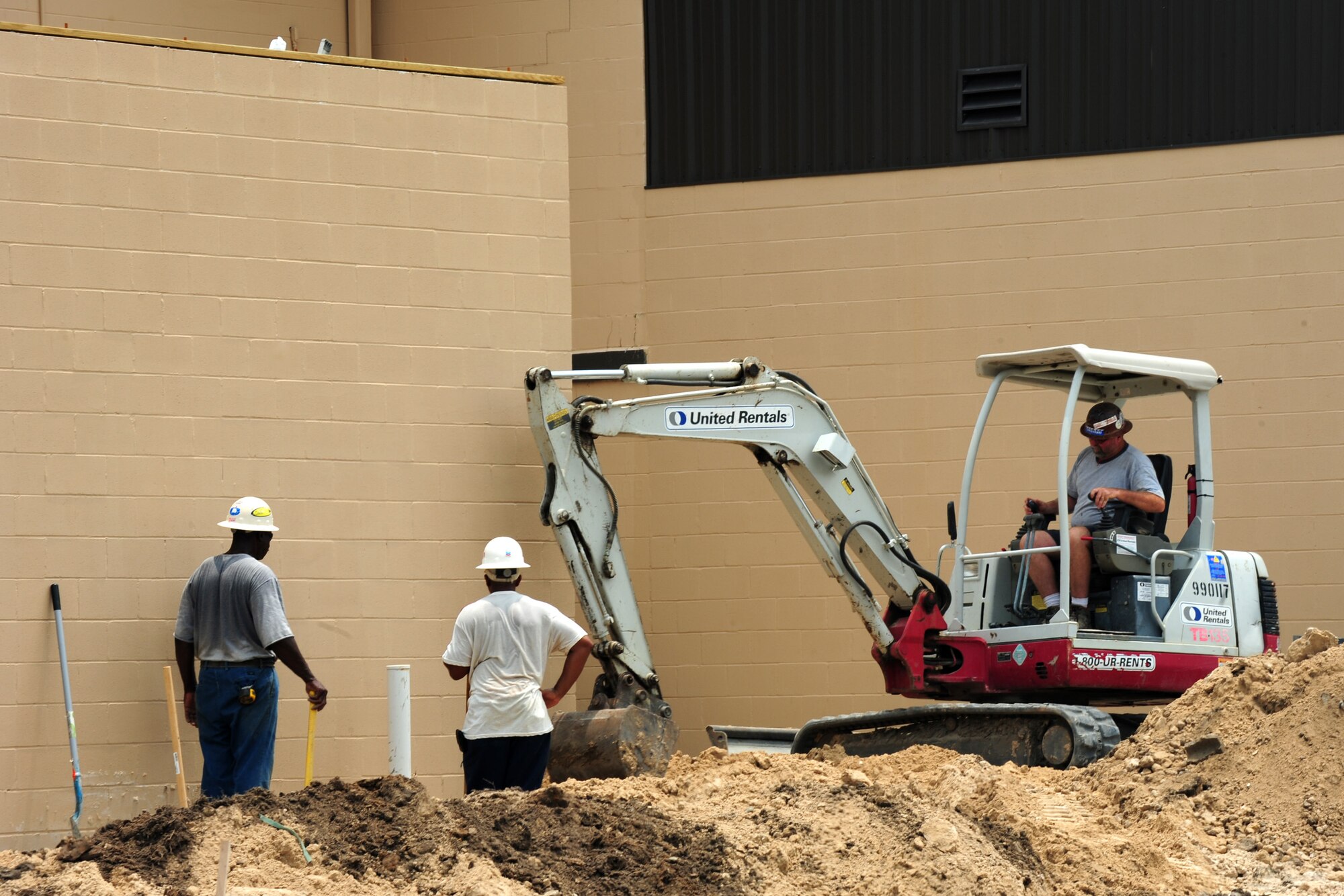 Contractors use a bulldozer to layout dirt before laying concrete outside the Hoffman Theater at Moody Air Force Base, Ga., July 6, 2011. The theater renovations are just one of many Moody projects that will increase the Airmen’s quality of life. (U.S. Air Force photo by Senior Airman Stephanie Mancha/Released)
