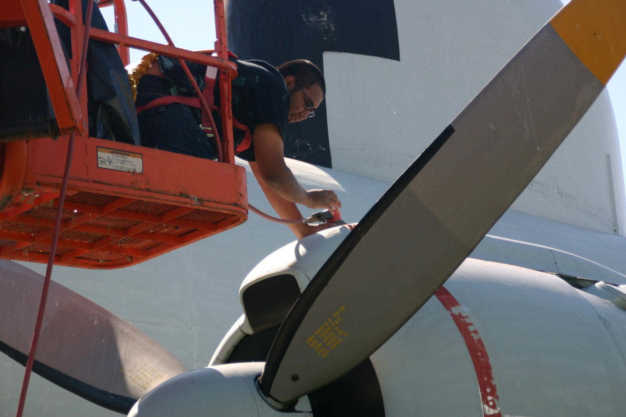 A member of the team formed to restore the EC-121 Constellation works on stripping the aircraft before it gets repainted. The Oklahoma elements had taken its toll on the ‘Connie,’ which sits in the 552nd Air Control?Wing’s Memorial Park.
