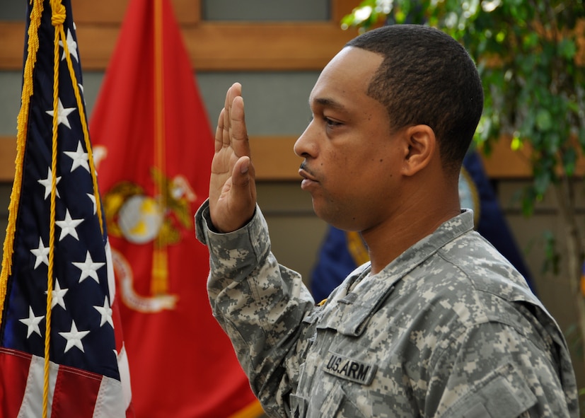 Army Staff Sgt. Joseph A. Green III, recites the Oath of Enlistment during a reenlistment ceremony at the Charles C. Carson Center for Mortuary Affairs July 5, 2011. Sergeant Green works with Army families who travel to Dover Air Force Base, Del., to witness the dignified transfer of a loved one. The Norfolk, Va., native is assigned to the Casualty and Mortuary Affairs Operations Center, U.S. Army Human Resources Command, Fort Knox, Ky. (U.S. Air Force photo/Christin Michaud)