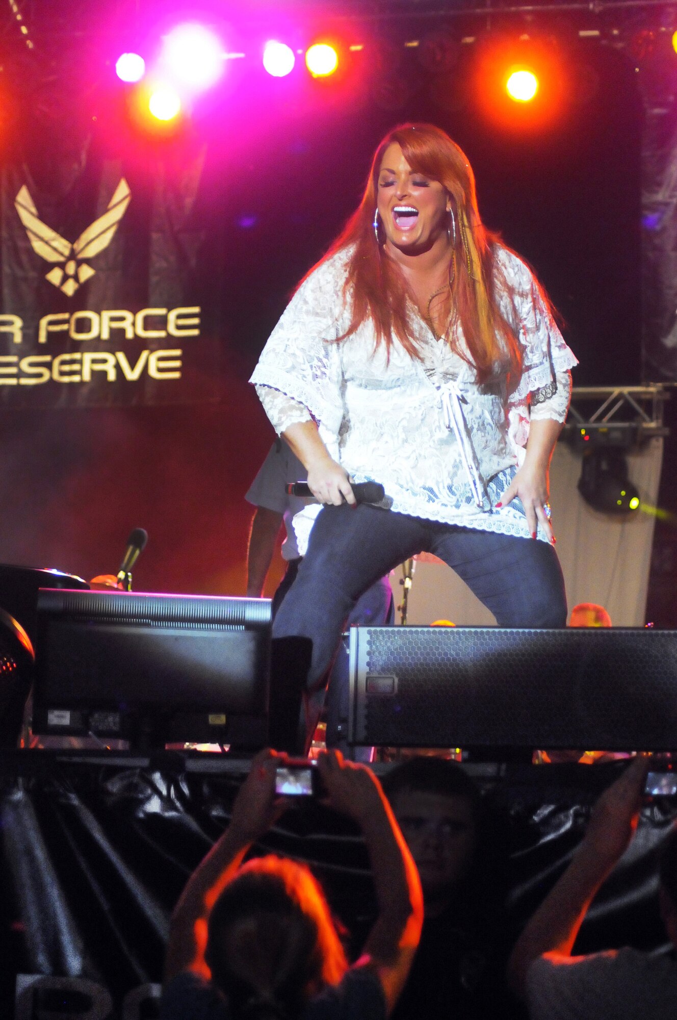 Wynonna Judd pauses during her performance to allow a youth to take a close up photo. U. S. Air Force photo by Sue Sapp