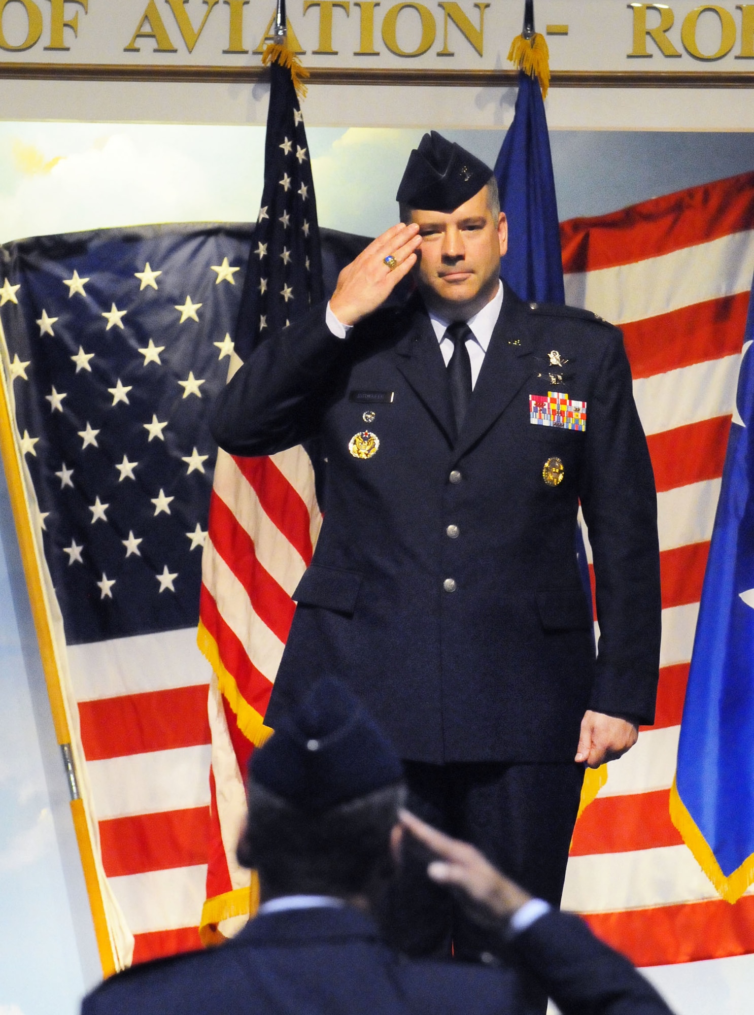 Colonel Mitchel H. Butikofer renders his first salute to members of the 78th Air Base Wing after taking command of the wing during a change of command ceremony at the Museum of Aviation. U. S. Air Force photo by Sue Sapp