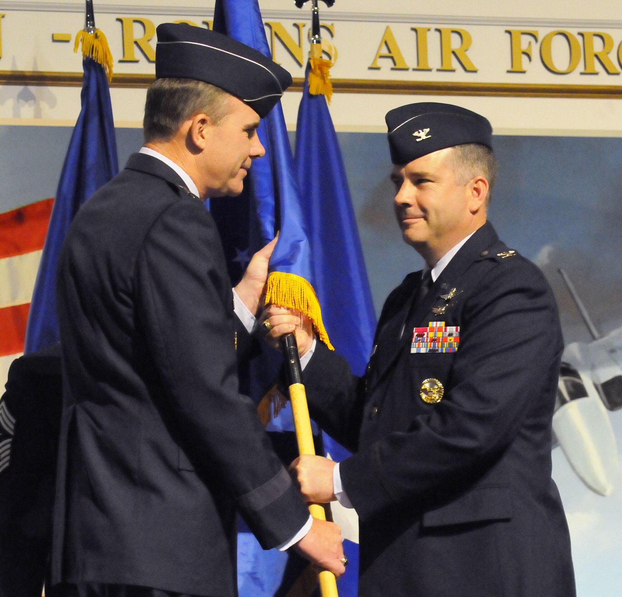 Colonel Mitchel H. Butikofer (right) accepts the guidon from Major General Robert McMahon, Warner Robins Air Logistics Center commander, to take command  of the 78th Air Base Wing during a ceremony at the Museum of Aviation June 30. U. S. Air Force photo by Sue Sapp
