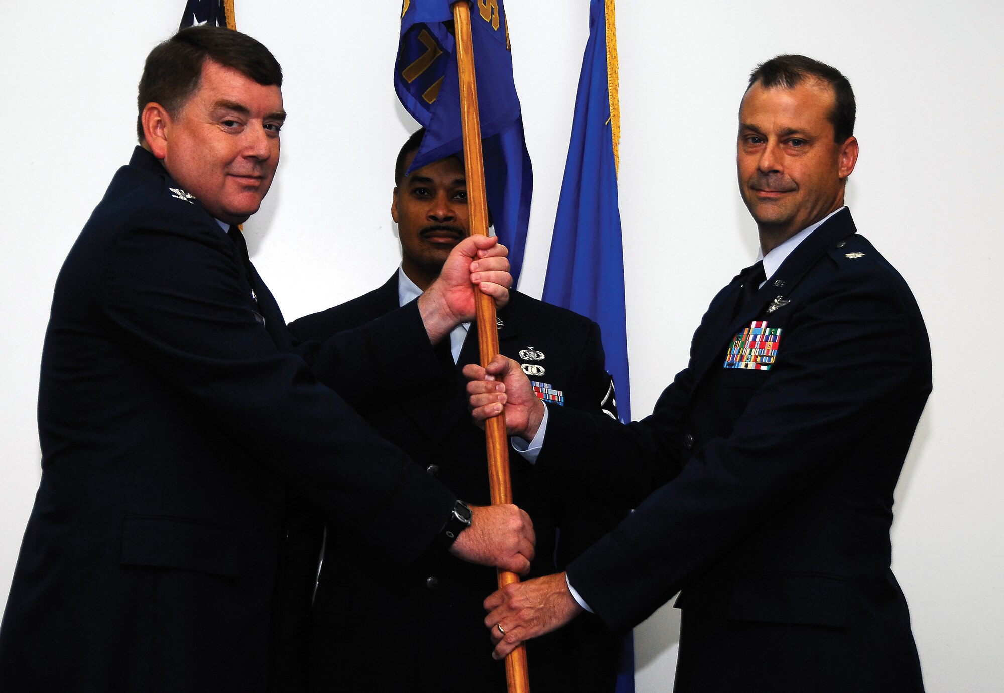 Col. Edward Jennings, 908th Operations Group commander, hands the guideon of the 357th Airlift Squadron to its new commander, Lt. Col. Craig Drescher.