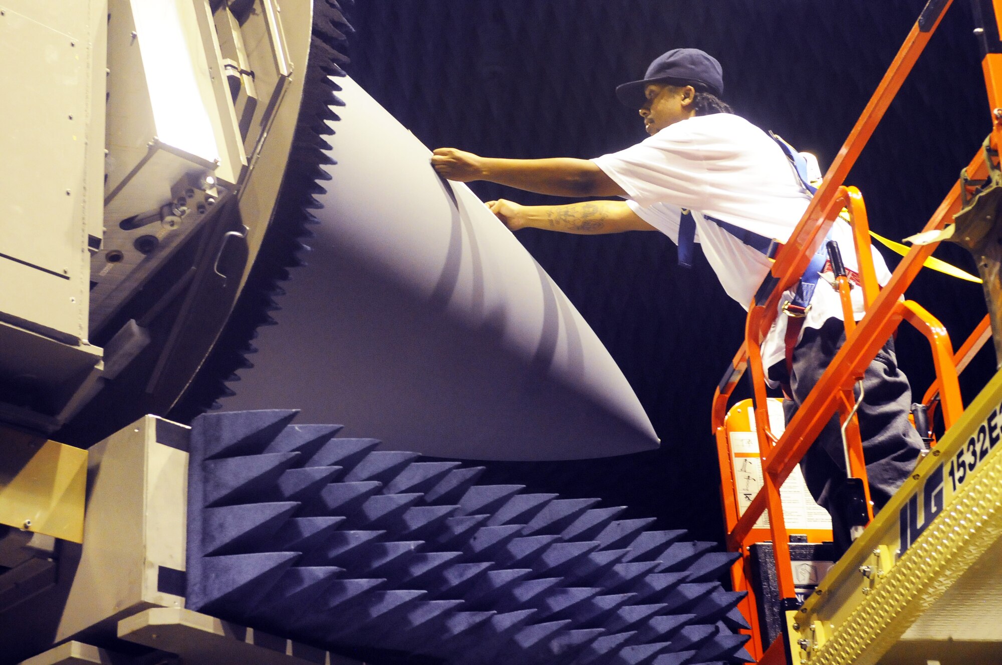 Clarence Thrower, electronic technician, makes corrections to a radome by adding tape. U. S. Air Force photo by Sue Sapp