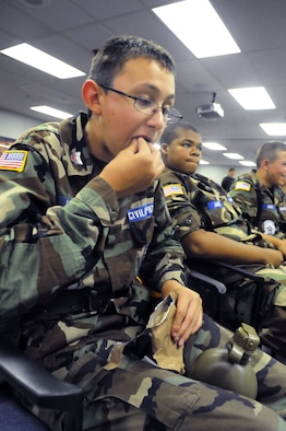 SSgt. Chris Jossart eats a MRE during the Civil Air Patrol encampment at Robins. U. S. Air Force photo by Sue Sapp