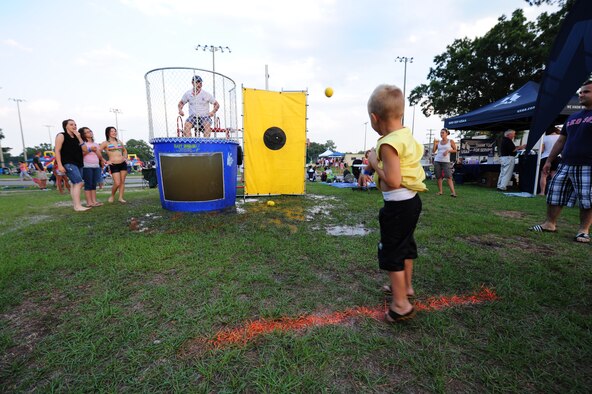SEYMOUR JOHNSON AIR FORCE BASE, N.C. – Pierce McCardle, 4, attempts to dunk Master Sgt. Paul Money during the Independence Day celebration here, June 30, 2011. Pierce is the son of Staff Sgt. David McCardle, 4th Fighter Wing dormitory manager, who hails from Dixon, Tenn. (U.S. Air Force photo/Senior Airman Rae Perry/Released)