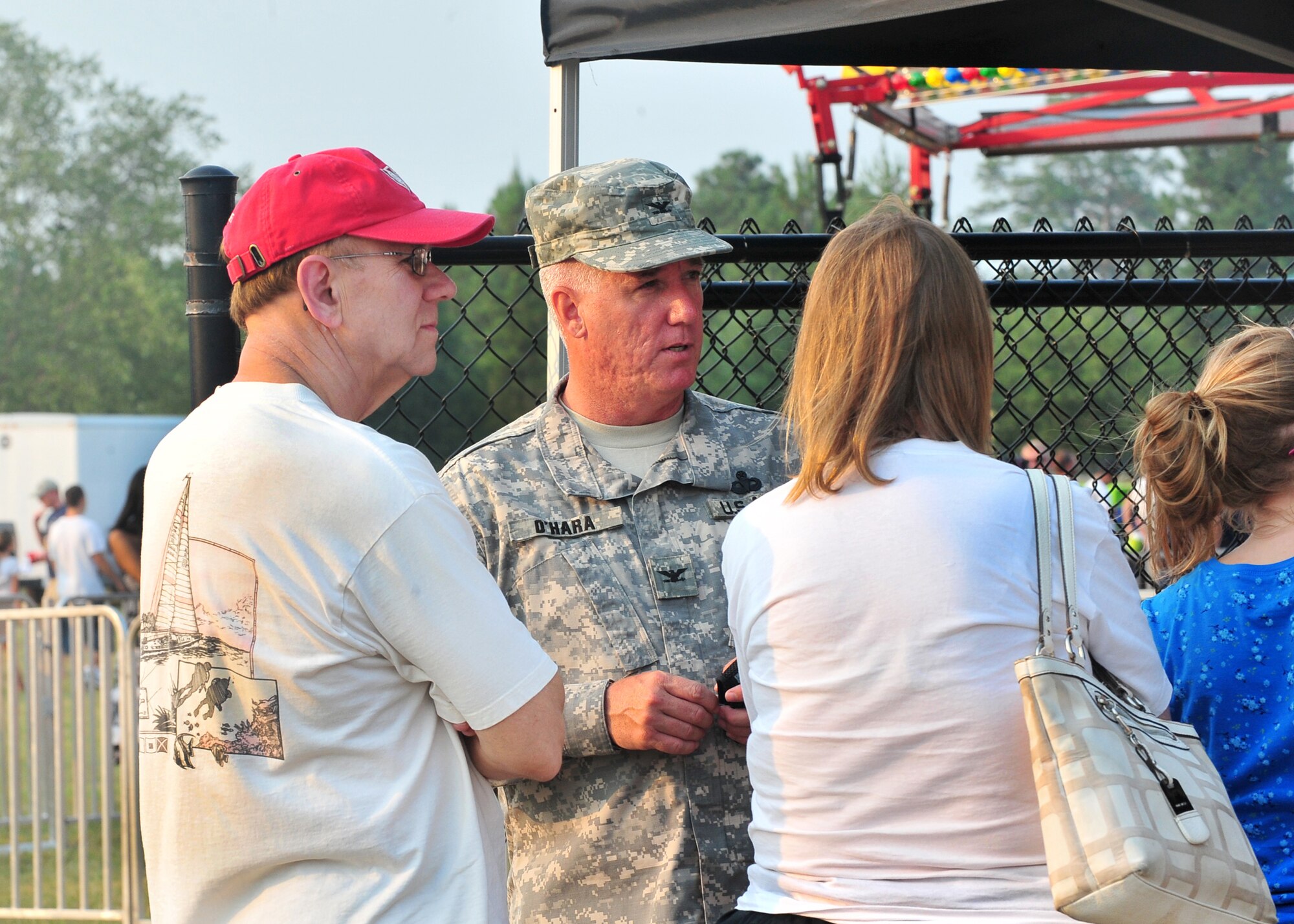SHAW AIR FORCE BASE, S.C.-- Army Col. Gerald O'Hara, Third Army/ Army Central Public Affairs chief, converses with community members during the Jammin' July 4th celebration. The celebration allows the Sumter community and  Team Shaw to come together annually for food, fun and a fireworks show. Shaw helps sponsor the event every year to give back to the community for the support throughout the year. (U.S. Air Force photo by Airman 1st Class Ashley Gardner/ Released)