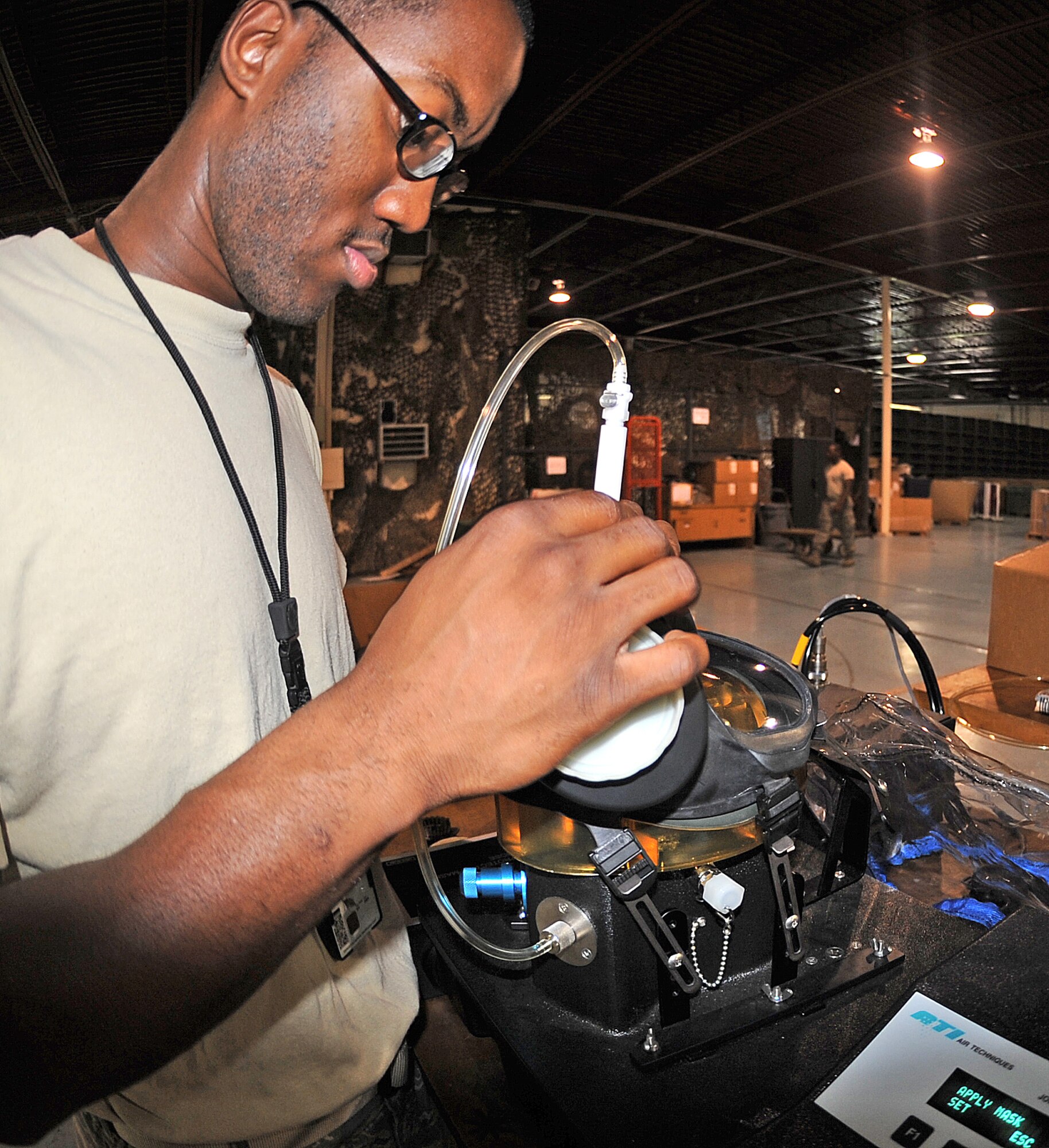 SEYMOUR JOHNSON AIR FORCE BASE, N.C. - Senior Airman Antwun Cotton, 4th Logistics Readiness Squadron individual protective equipment technician, performs an inspection on an M-50 gas mask at the IPE shop here July 6, 2011. Gas mask serviceability must be checked prior to being issued to deploying Airmen. Cotton hails from Greenville. (U.S. Air Force photo/Senior Airman Gino Reyes)(Released)