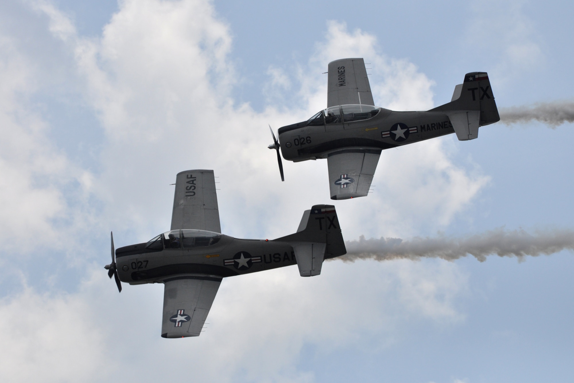 Col. (Ret) John “Slick” Sledge, U.S. Marine Corps, and Col. (Ret) Chip Lamb, U.S. Air Force, fly their North American T-28 Trojan Trainer Aircraft during the “Wings Over Tyler Air Show” at the Tyler Pounds Regional Airport in Tyler, Texas, July 3, 2011. Colonels Sledge and Lamb fly with the Trojan Phlyers T-28 Flight Demonstration Team from Fort Worth, Texas. They were featured performers at the air show. In 1962, North American began supplying T-28Ds for a counter-insurgency role. The T-28 saw action in both Southeast Asia and North Africa. (U.S. Air Force photo/Tech. Sgt. Jeff Walston)       